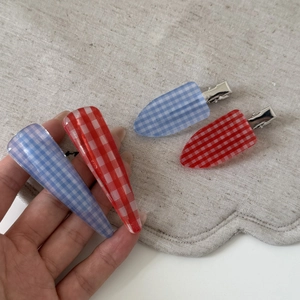 Detail of red and blue plaid acetate hair clips with silver metal duckbill base