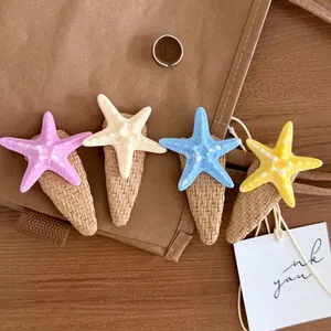 Detailed close-up of colorful starfish hair clips with woven fabric wrapped base