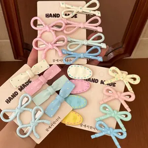 Pastel cream-colored water drop hair clips with hand-painted patterns on handmade cards