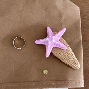 Pink starfish hair clip with woven base and silver minimalist open ring accessory