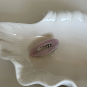 Pink acetate oval hollow hair clip with Barrette La France text on shell tray