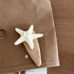 Tropical cream starfish hair clip with woven texture base for beach style hair styling