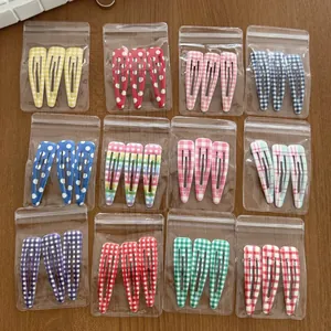 Detailed view of 36 piece set featuring colorful gingham and polka dot snap hair clips