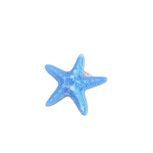 Blue starfish napkin ring with realistic texture and white woven back loop for coastal decor