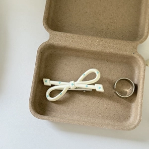 Polished silver open ring and cream bow hair clip with blue dots in a kraft gift box