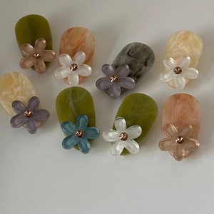 Detailed macro view of colorful acetate flower hair clips with central rhinestone