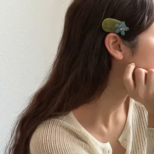 Elegant Korean style olive green flower hair clip with rhinestones worn by a model