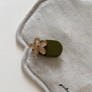 Detail of Korean green floral hair clip with champagne petal and small rhinestone