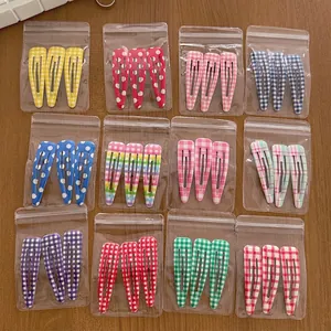 Set of colorful checkered and polka dot metal hair clips in various vibrant designs