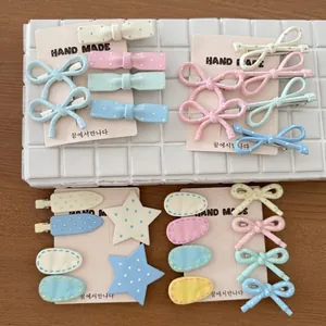 Pastel macaron color hair clip set with sweet polka dot pattern on cream display card