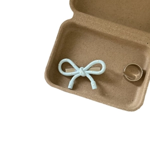 Light blue polka dot bow hair clip and silver ring in a minimalist gift box