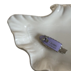 Sparkling grape purple cherry hair clip with rhinestones on a white shell plate