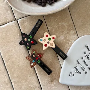Chic acetate star hair clips set with colorful rhinestones in black and cream colors