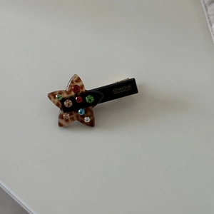 Star-shaped acetate clip with colorful rhinestones and tortoiseshell pattern