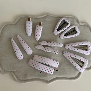 Retro red polka dot fabric hair clip set on a textured linen tray for women and girls
