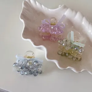 Three-piece set of elegant beaded crystal bow mini hair claws in pink, blue, and green