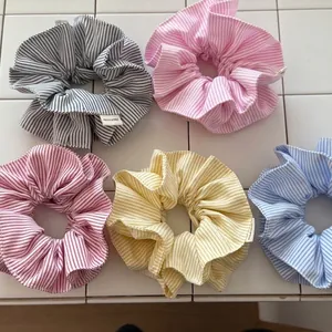 Set of 5 colorful striped scrunchies in pastel tones with handmade fabric labels