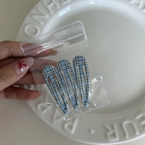 Set of three blue and white plaid BB hair clips in transparent polybag packaging