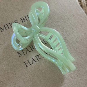 Pale green pearlescent ribbon bow hair claw clip made of iridescent resin material