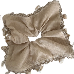 Beige cotton linen hair scrunchie with lace edges and natural shell pendants for beach vacation