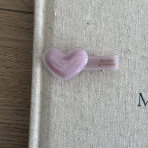 Macro detail of lavender heart-shaped acetate hair clip with golden Barrette La France text
