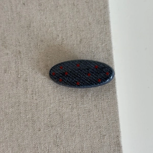 Polka dot denim blue oval hair clip with red spots and textured resin finish for women