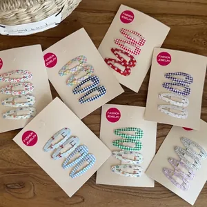 Set of 4 cute snap hair clips with floral and polka dot prints for girls' daily styling