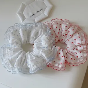 Fresh polka dot tulle scrunchies in blue and red with delicate wavy lace edges