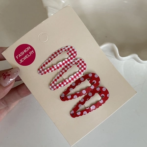 Detailed set of 4 drop-shaped hair clips with red plaid and polka dot patterns on a card