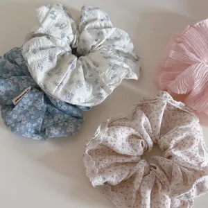 Floral print scrunchie set in light blue and pink with elegant lace trim details