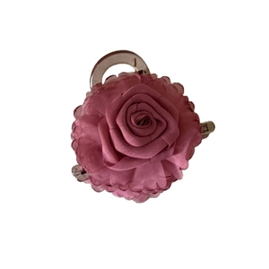Elegant pink fabric rose hair claw clip with satin texture and transparent base