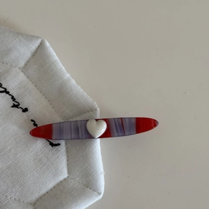 French red marble acetate hair clip with white heart detail for a vintage elegant look