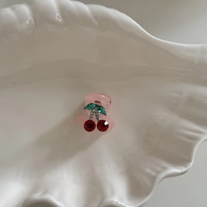 French vintage cherry hair claw with red rhinestones on a white shell tray
