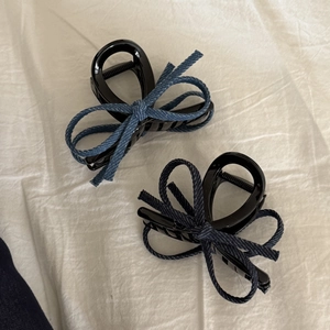 Retro denim bow hair claws with polished black finish and frayed edge detailing