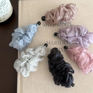 Detailed view of six pleated chiffon fabric banana hair clips in assorted pastel colors