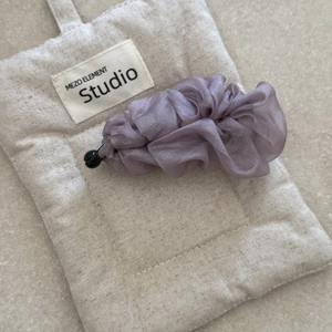 Elegant purple pleated chiffon banana hair clip for high ponytail on fabric background