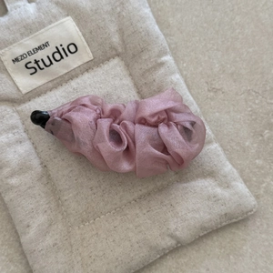 Detail of elegant dusty rose chiffon ruffled banana clip with non-slip vertical grip
