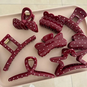 Set of 7 burgundy hair claws with white polka dots in star, heart, and bow shapes