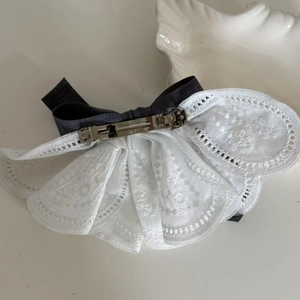 Detail of elegant lace hair clip with embroidery texture and metal spring closure