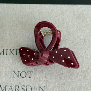 French vintage dark red hair claw clip with white polka dots in a bow shape design