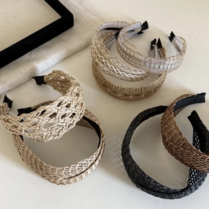 Detail showing handwoven straw texture and intricate lace patterns of bohemian headbands