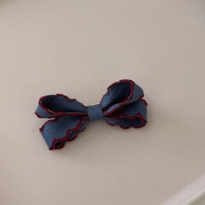 Blue denim bow hair clip with decorative red scalloped edges and sweet Korean style design