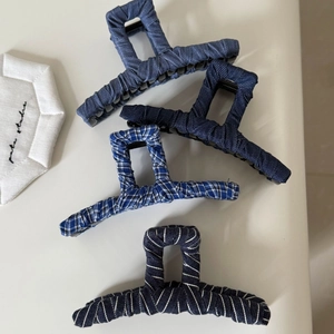 Set of four blue denim fabric wrapped shark hair claws in striped and plaid patterns