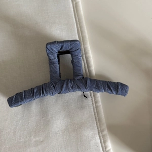 Detail of blue denim fabric rectangular hair claw clip with sturdy spring mechanism