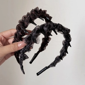 Two leopard print ruffled headbands with built-in hair combs and handmade details