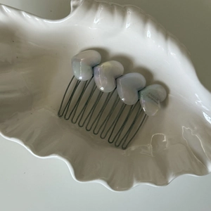 Macro detail of acetate heart hair comb with France Handmade engraving in shell tray