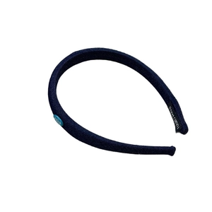 Minimalist denim blue fabric headband with brand label logo on white background