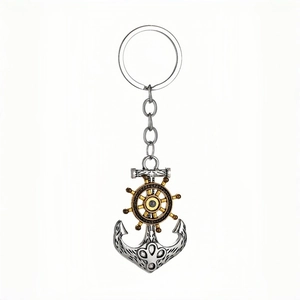 Vintage nautical keychain featuring a silver anchor and gold ship wheel on white background