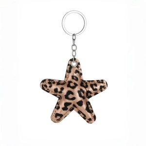 Leopard print star keychain made of PU leather with silver metal ring on white background