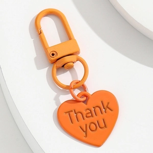 Porte-clés cœur orange mignon avec gravure Thank You sur un support blanc épuré